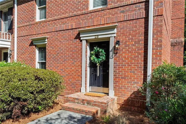 front view of a brick house with a large window