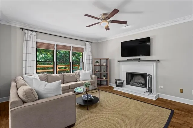 a living room with furniture a flat screen tv and a fireplace