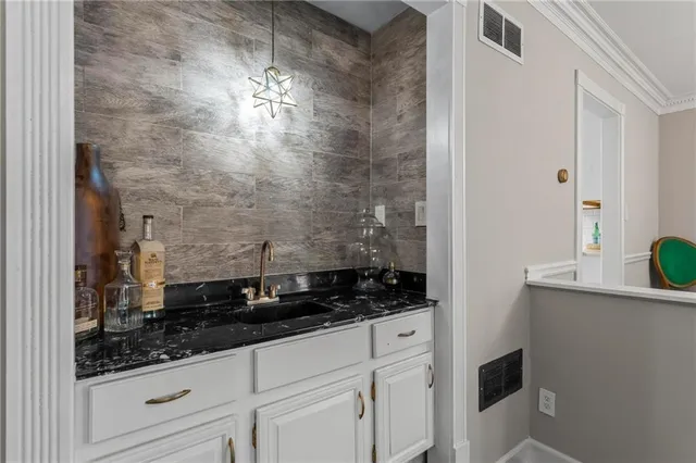 a bathroom with a granite countertop sink a vanity and shower