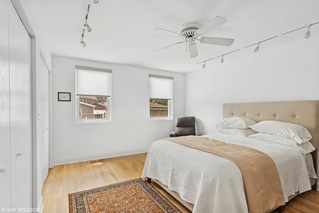 a bedroom with a bed and a chandelier