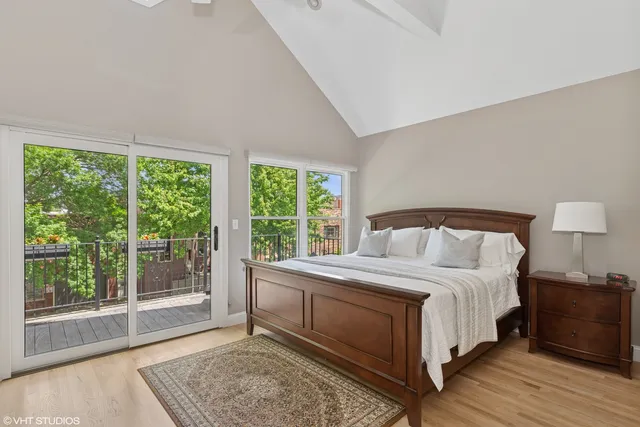 a bedroom with a bed and a large window
