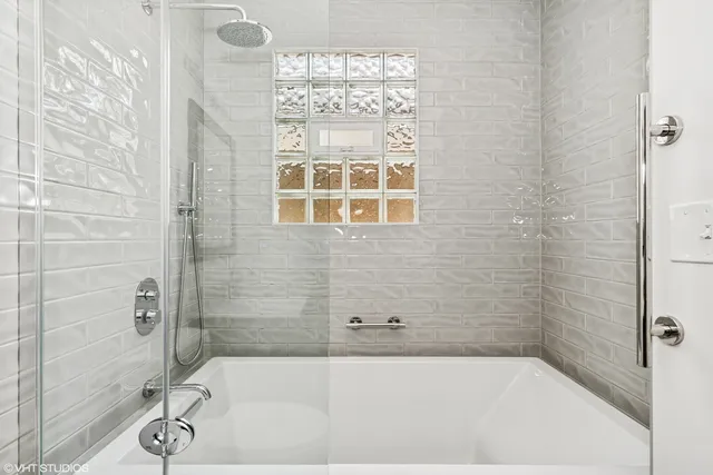 a bathroom with a bathtub and shower