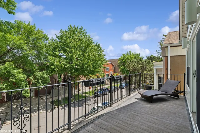 a view of a balcony with chair and wooden fence