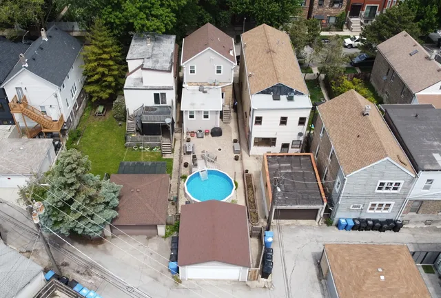 an aerial view of a house with outdoor space and sitting area