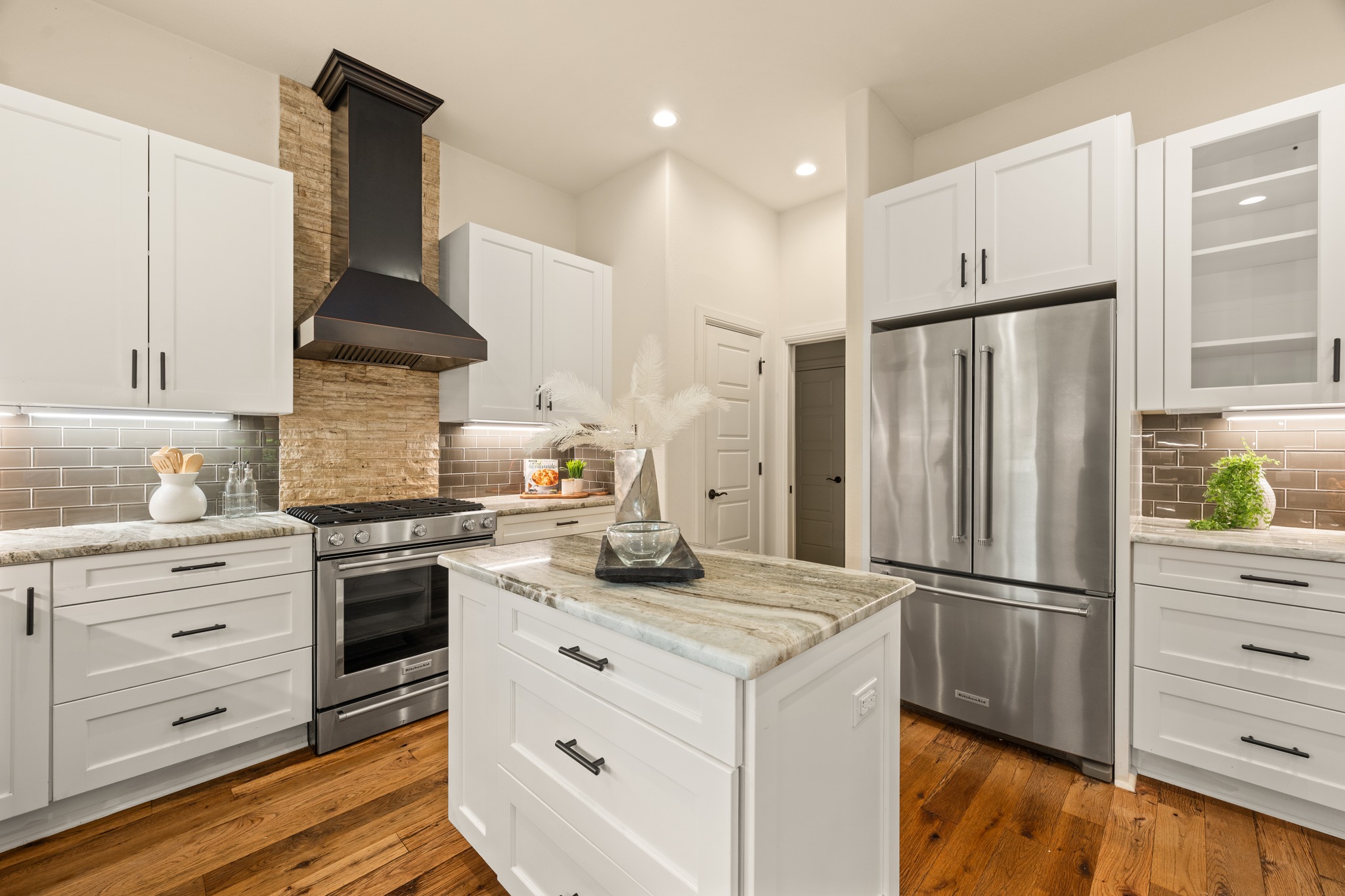 3907 Bailey Lane Austin, TX 78756 - Photo 12 of 40 Stainless steel appliances enhance the modern feel of the kitchen and include a gas cooktop, dishwasher, and vent hood