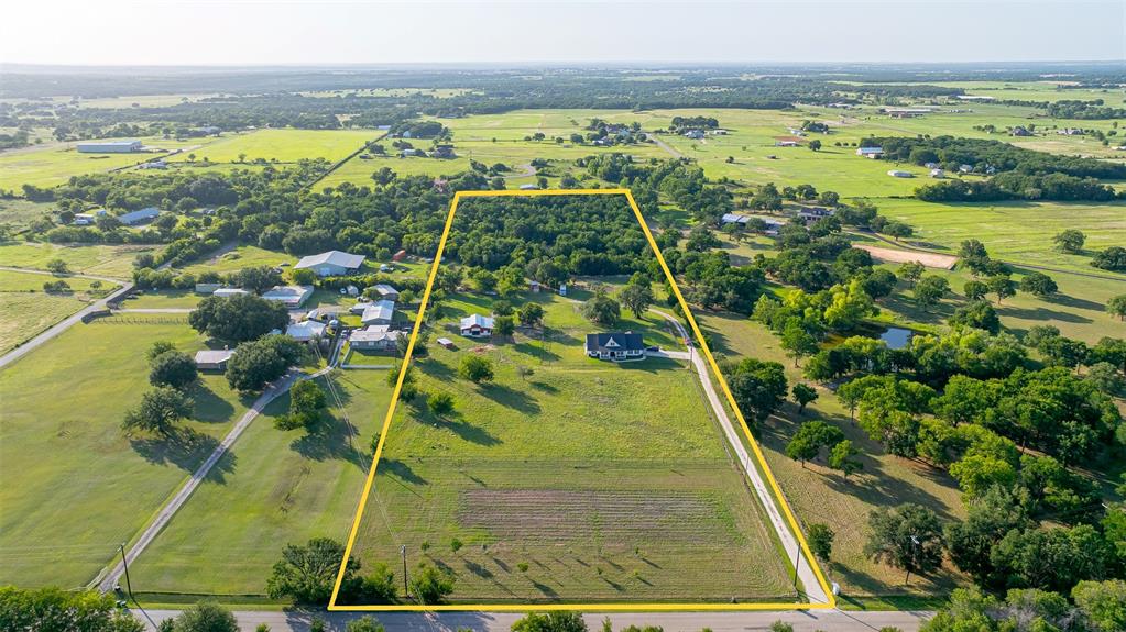 1920 Meander Road Granbury, TX 76049 - Photo 39 of 40 Expansive rural property featuring a substantial treed area, open grassy fields, and a residential structure
