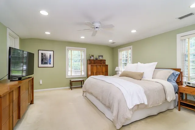 a bedroom with a large bed and a flat screen tv