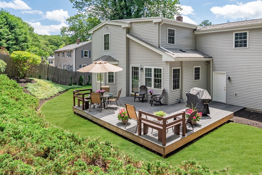 50 Felch Road Natick, MA 01760 - Photo 25 of 32 a view of a house with backyard and sitting area