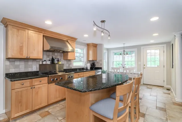 a kitchen with granite countertop a sink stainless steel appliances and cabinets
