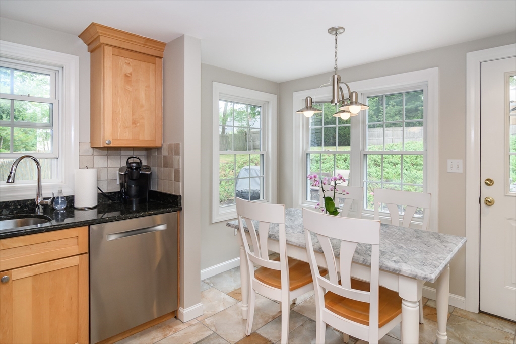 50 Felch Road Natick, MA 01760 - Photo 6 of 32 a dining room with granite countertop a sink a counter top space and living room view