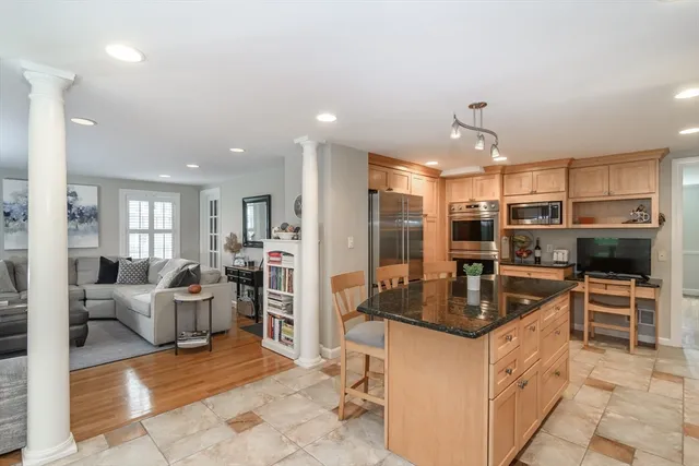 a kitchen with refrigerator and cabinets