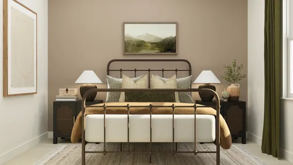 a bed sitting in a bedroom next to a window