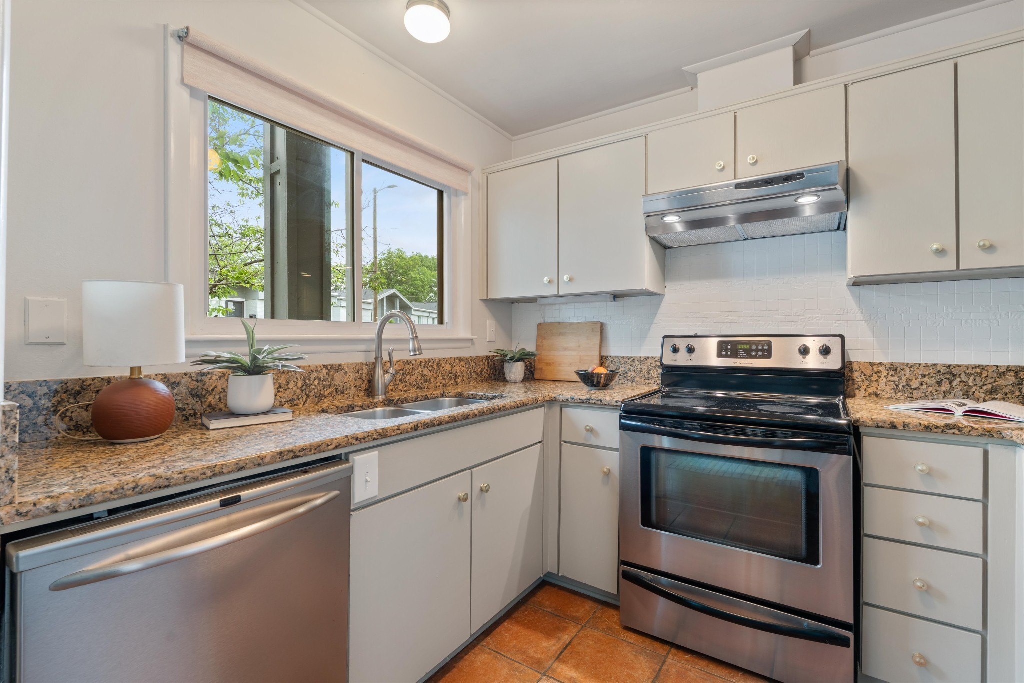 1900 Richard Jones Road, Unit P2 Nashville, TN 37215 - Photo 7 of 20 a kitchen with granite countertop white cabinets appliances and a large window