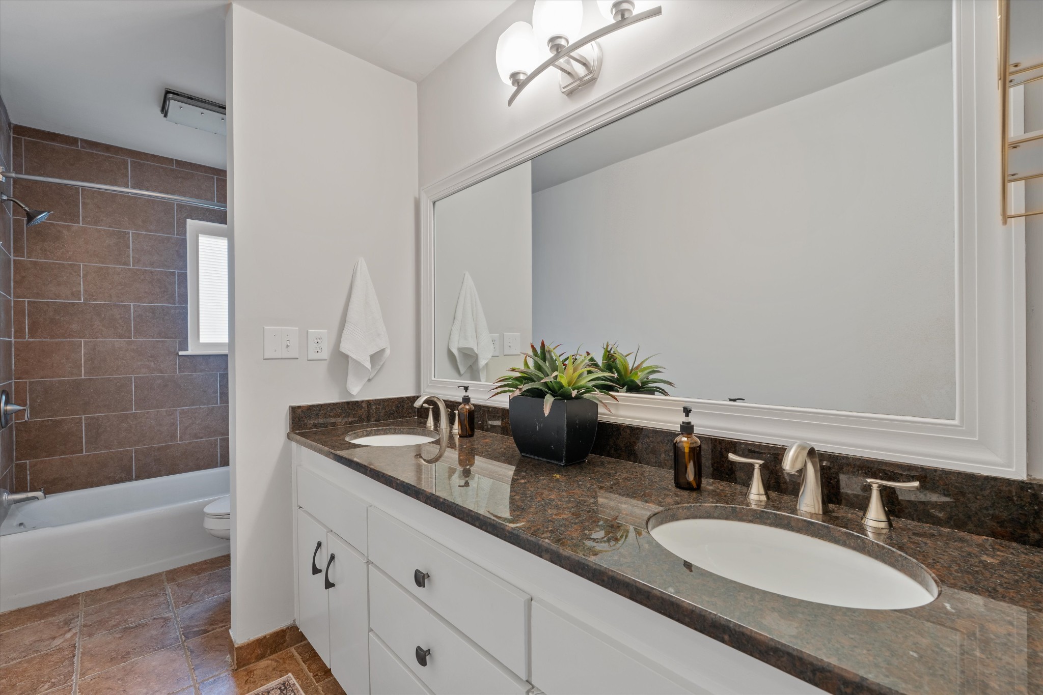 1900 Richard Jones Road, Unit P2 Nashville, TN 37215 - Photo 9 of 20 a bathroom with a granite countertop sink a mirror and a bathtub