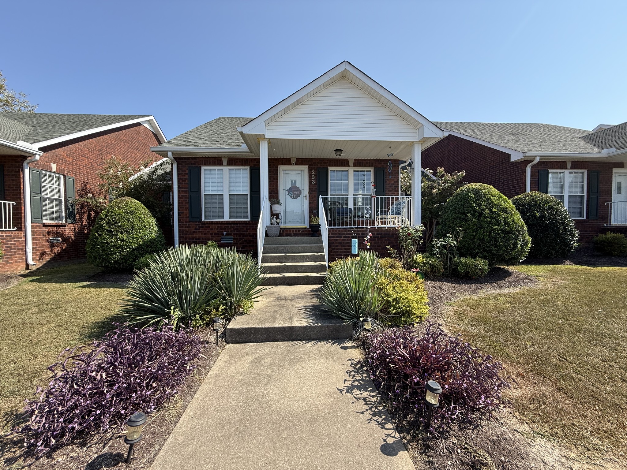 233 Winfrey Court Pleasant View, TN 37146 - Photo 3 of 28 a front view of a house with a yard and potted plants