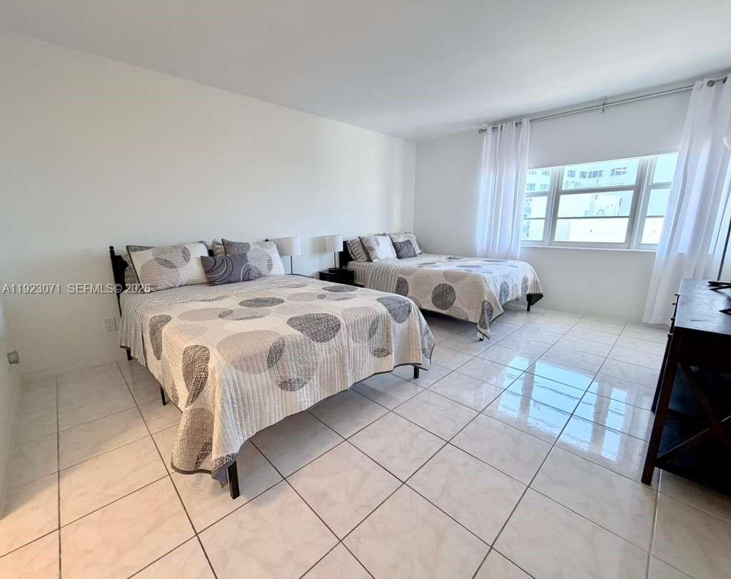 100 Lincoln Road, Unit 541 Miami Beach, FL 33139 - Photo 10 of 17 a bedroom with a bed and a view of living room