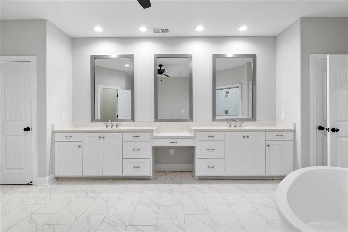 80 Fairview Trail Byhalia, MS 38611 - Photo 10 of 25 a spacious bathroom with a granite countertop sink and a mirror