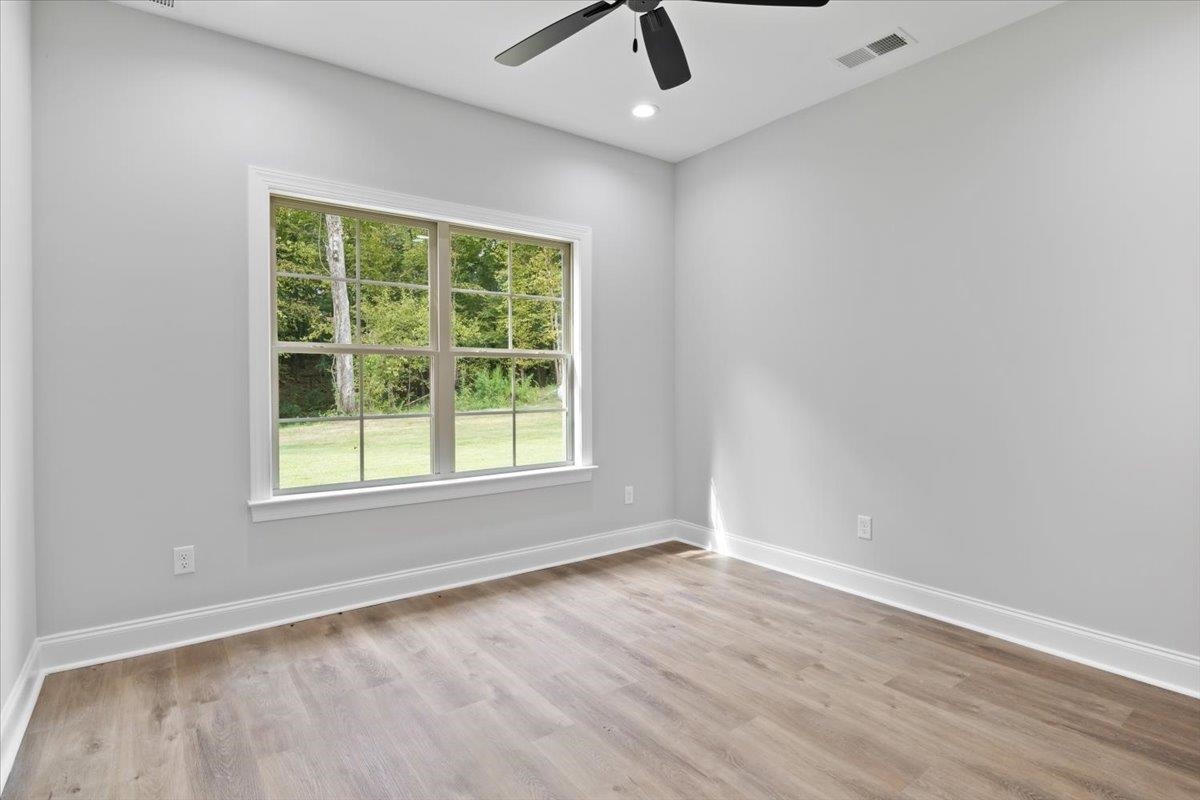 80 Fairview Trail Byhalia, MS 38611 - Photo 14 of 25 an empty room with a window and a ceiling fan
