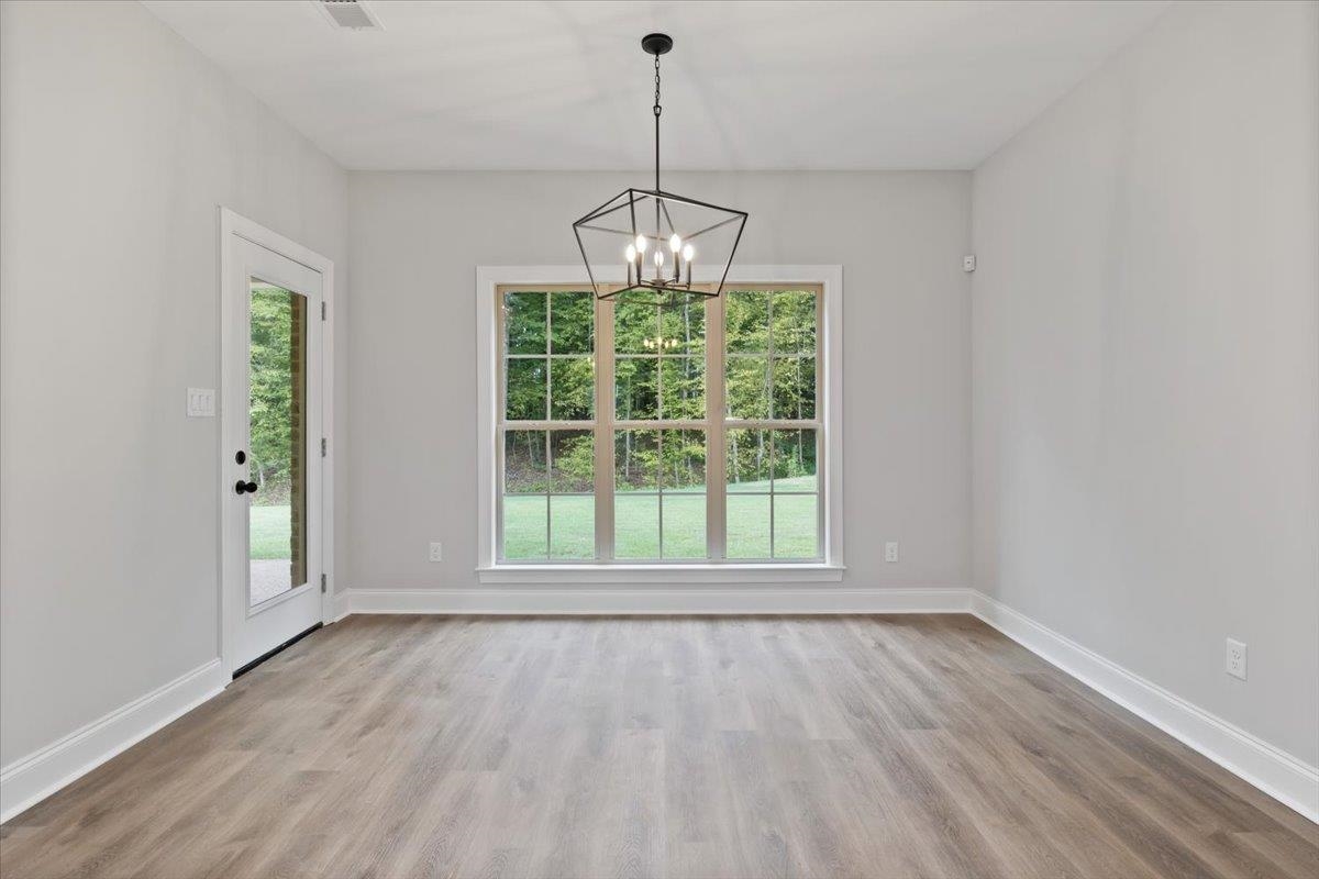 80 Fairview Trail Byhalia, MS 38611 - Photo 8 of 25 an empty room with wooden floor and windows