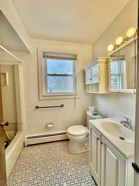 17 Maple Street, Unit 2 Braintree, MA 02184 - Photo 15 of 25 a bathroom with a sink toilet a mirror and vanity