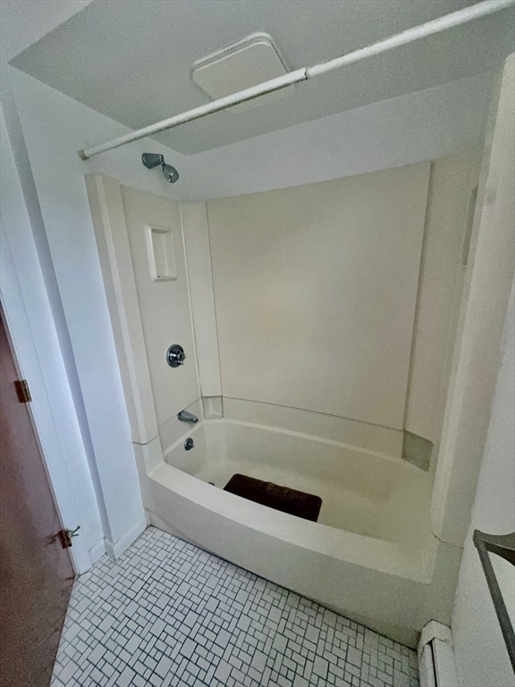17 Maple Street, Unit 2 Braintree, MA 02184 - Photo 16 of 25 a bathroom with a bathtub and a shower