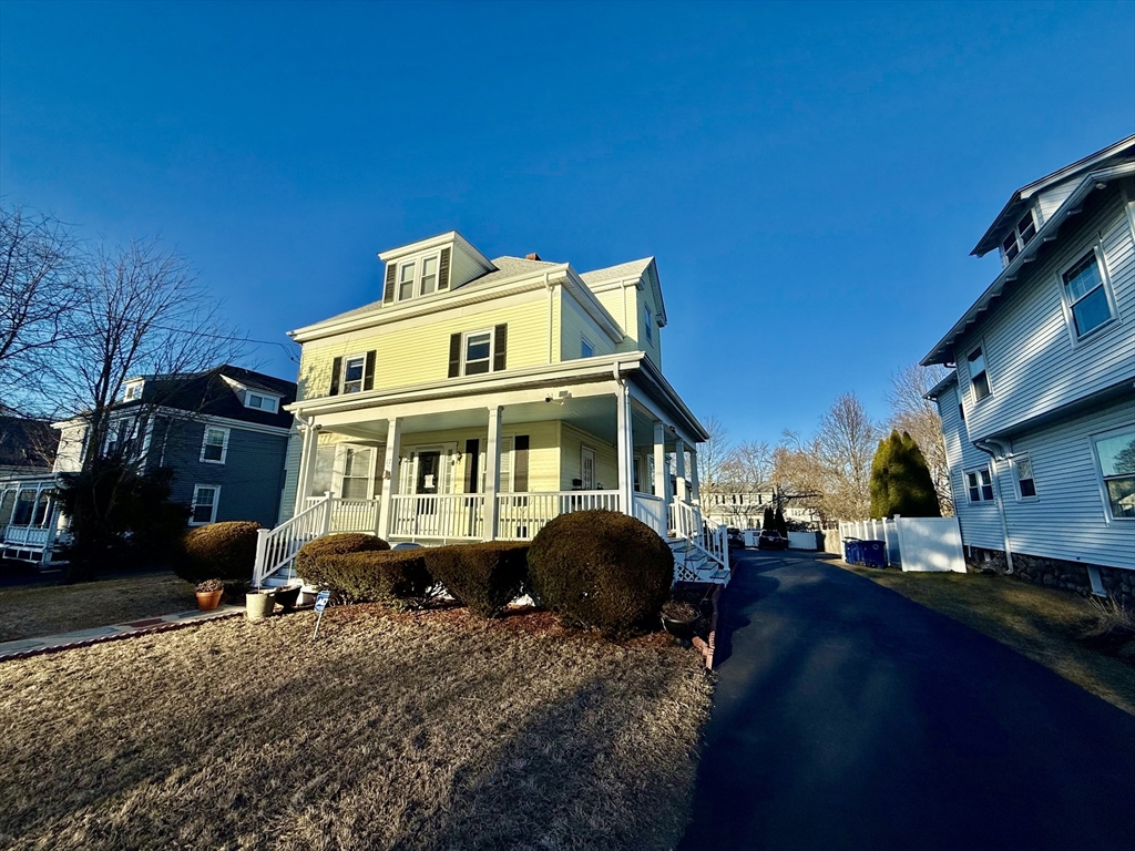 17 Maple Street, Unit 2 Braintree, MA 02184 - Photo 23 of 25 a front view of a house with a yard