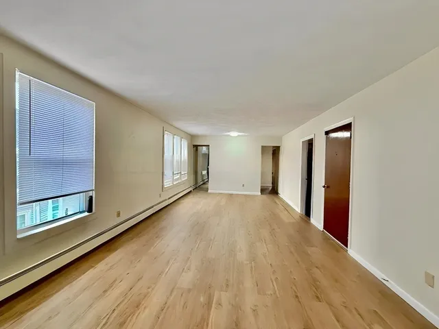 a kitchen with stainless steel appliances granite countertop a refrigerator sink and white cabinets