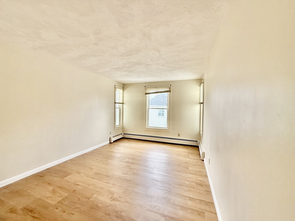 17 Maple Street, Unit 2 Braintree, MA 02184 - Photo 8 of 25 a view of an empty room and glass door