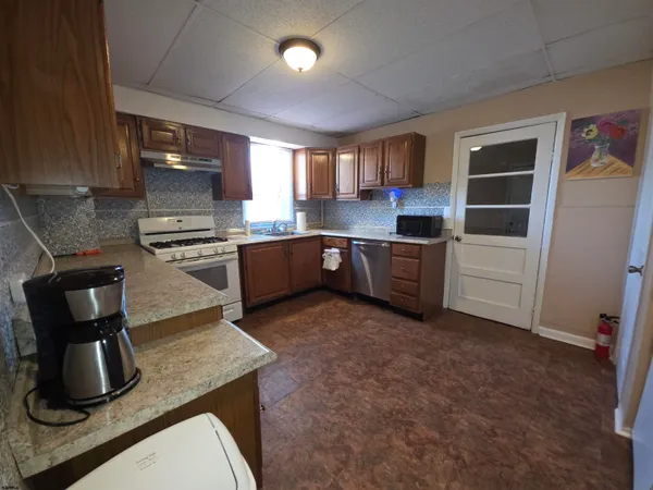 a kitchen with lots of counter top space and appliances