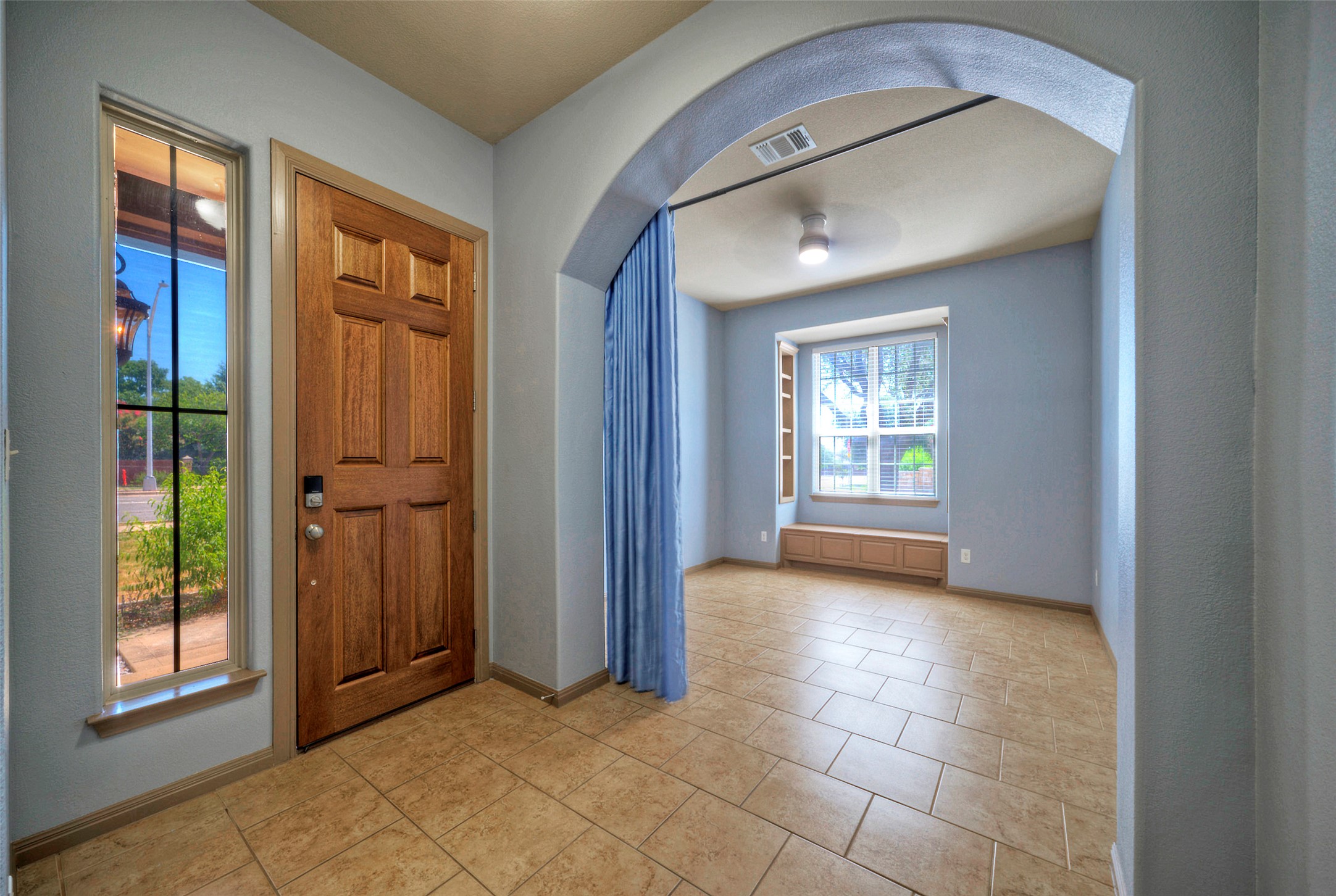 1601 Nelson Ranch Loop Cedar Park, TX 78613 - Photo 8 of 30 An arched entryway with tile flooring opens into a versatile front room.