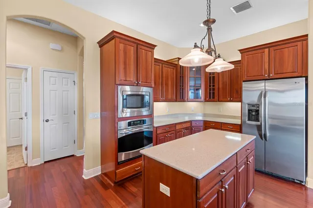a kitchen with stainless steel appliances a stove a refrigerator a sink and dishwasher