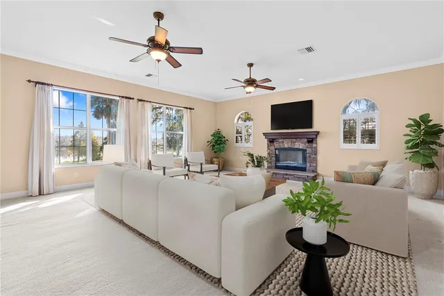 a living room with furniture a flat screen tv and a large window