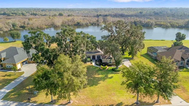 an aerial view of residential house with outdoor space and lake view