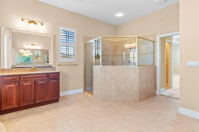 a spacious bathroom with a granite countertop sink mirror and