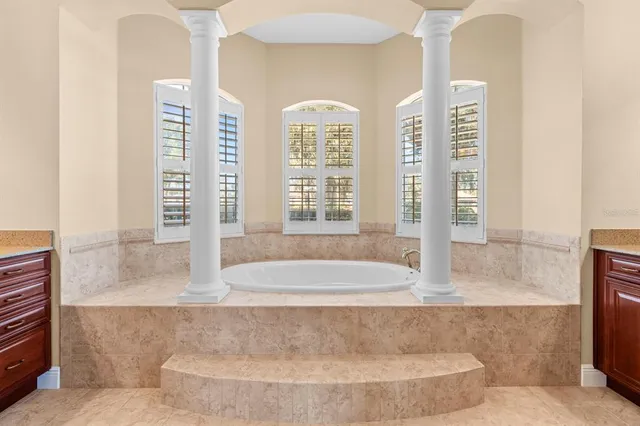 a living room with a large window and walk in closet