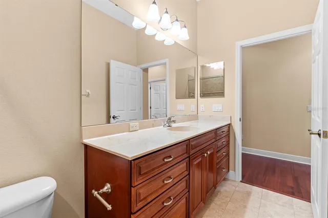 a bedroom with a large bed and a chandelier
