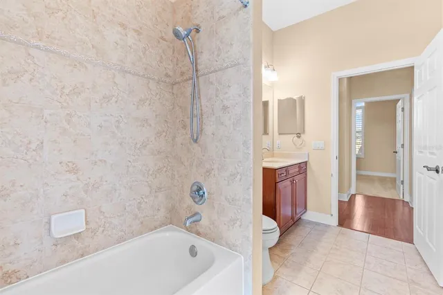 a view of an empty room with furniture and windows