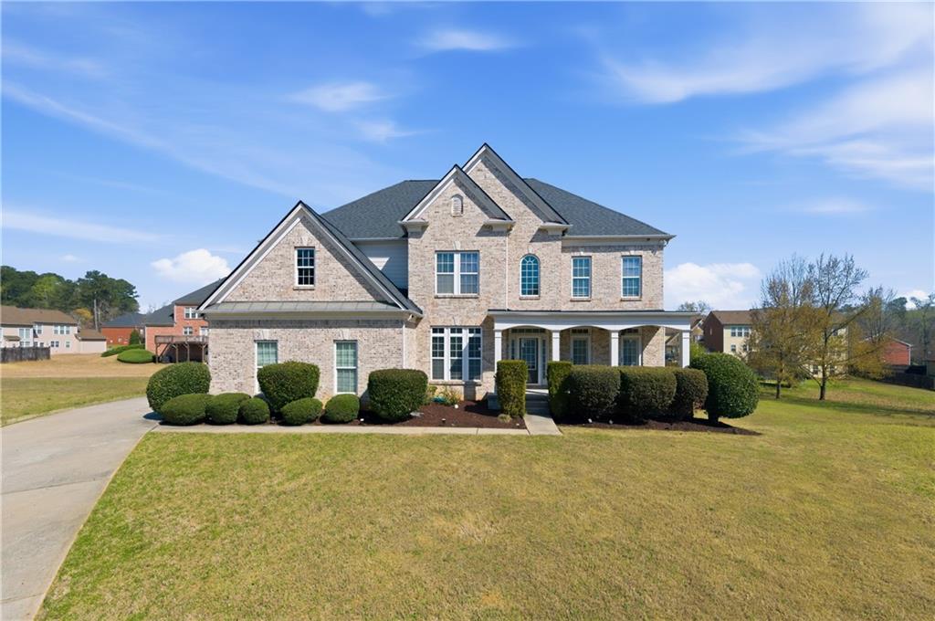 3173 Abbey Place Southwest Atlanta, GA 30331 - Photo 1 of 56 a front view of a house with a yard