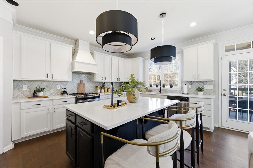 3173 Abbey Place Southwest Atlanta, GA 30331 - Photo 15 of 56 a kitchen with stainless steel appliances granite countertop a sink a stove and a dining table with wooden floor