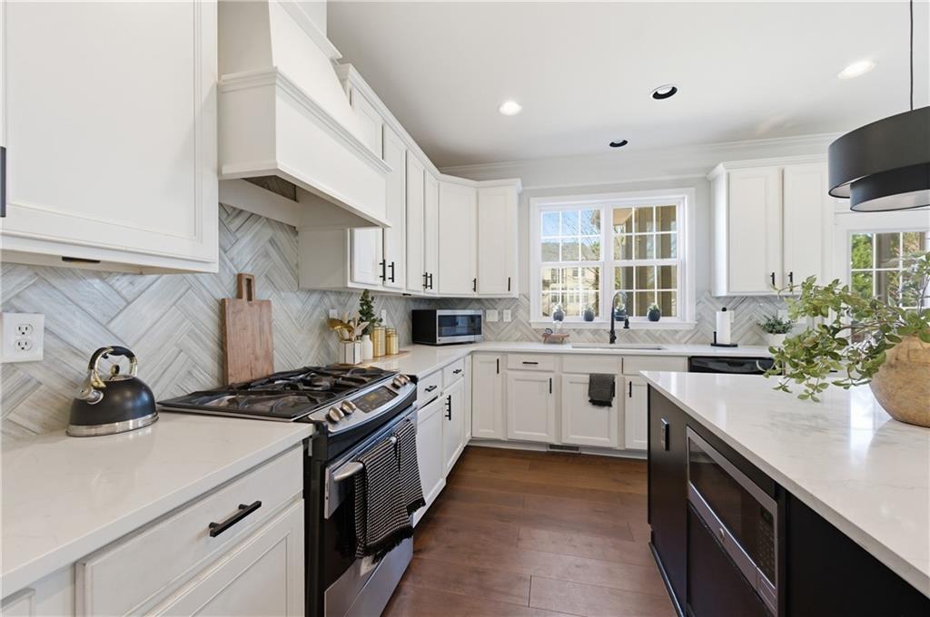 3173 Abbey Place Southwest Atlanta, GA 30331 - Photo 16 of 56 a kitchen with a sink stove and cabinets