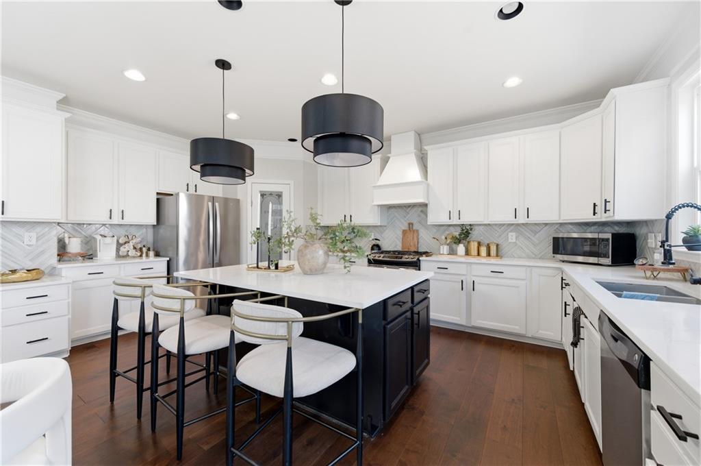 3173 Abbey Place Southwest Atlanta, GA 30331 - Photo 19 of 56 a kitchen with a stove cabinets and chairs