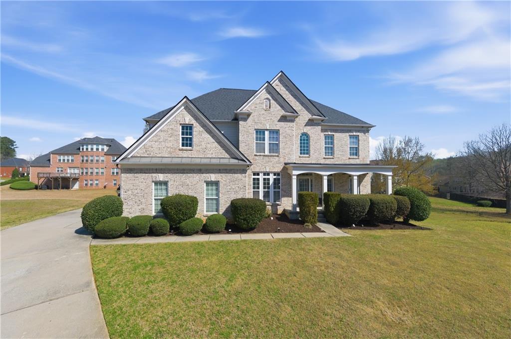3173 Abbey Place Southwest Atlanta, GA 30331 - Photo 2 of 56 a front view of a house with a yard