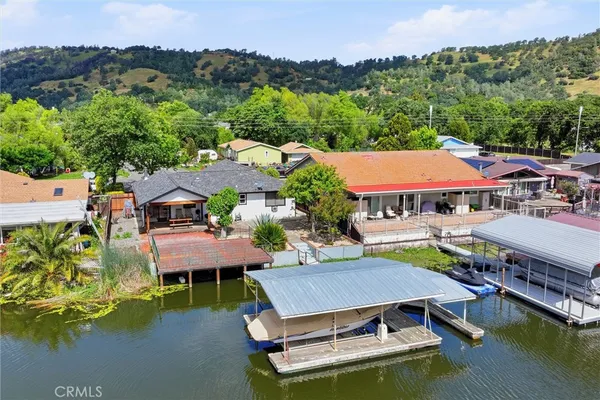 an aerial view of a house with swimming pool a patio and ocean view