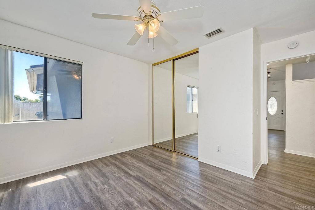 2131 Teal Glen Escondido, CA 92026 - Photo 18 of 35 a view of an empty room with wooden floor and a window