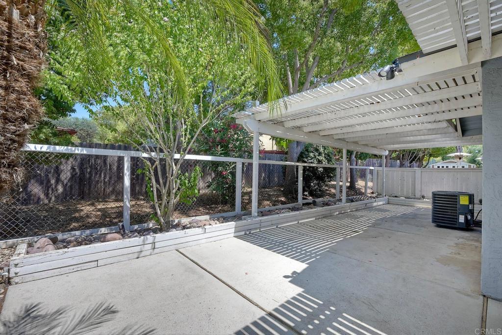 2131 Teal Glen Escondido, CA 92026 - Photo 31 of 35 a view of a patio with a table and chairs under an umbrella with a barbeque