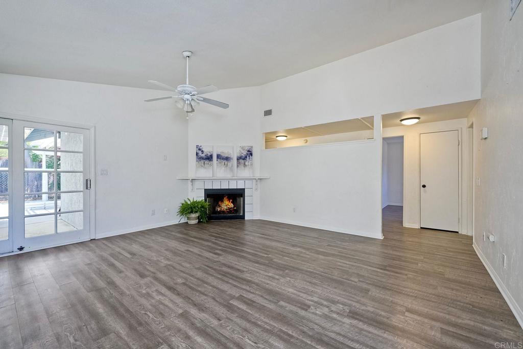 2131 Teal Glen Escondido, CA 92026 - Photo 9 of 35 an empty room with wooden floor fireplace and windows