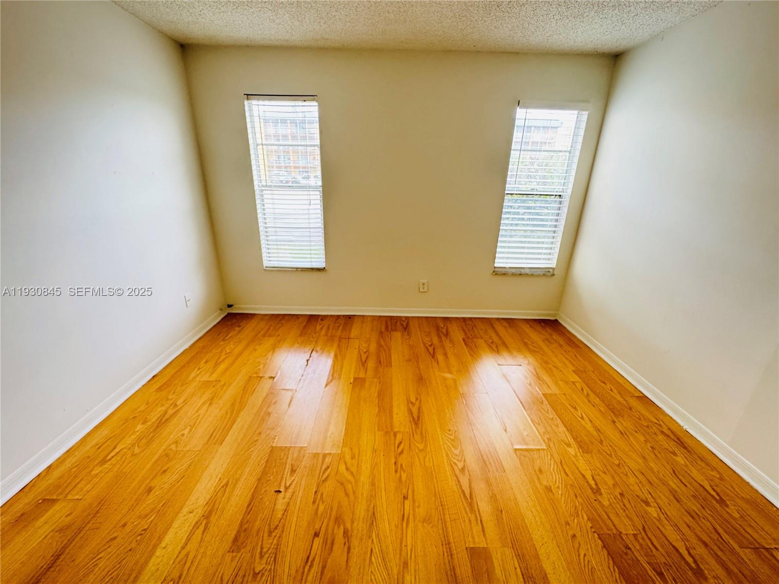 2800 Northwest 56th Avenue, Unit D102 Lauderhill, FL 33313 - Photo 12 of 25 a view of room with wooden floor and windows