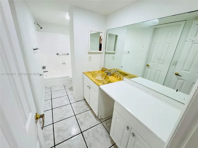 a white toilet sitting next to a bath tub