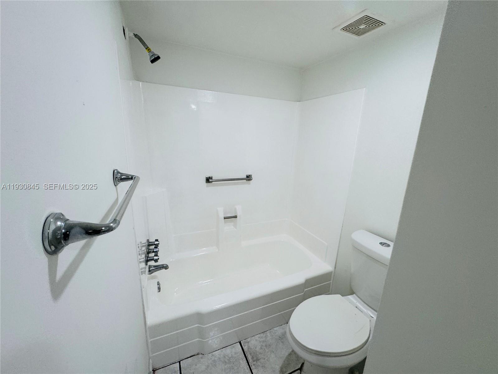2800 Northwest 56th Avenue, Unit D102 Lauderhill, FL 33313 - Photo 14 of 25 a white toilet sitting next to a bath tub
