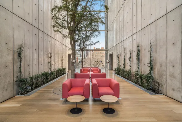 a building outdoor space with patio furniture and potted plants